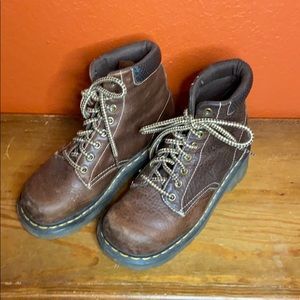 Dr. Martens lace up brown boots.